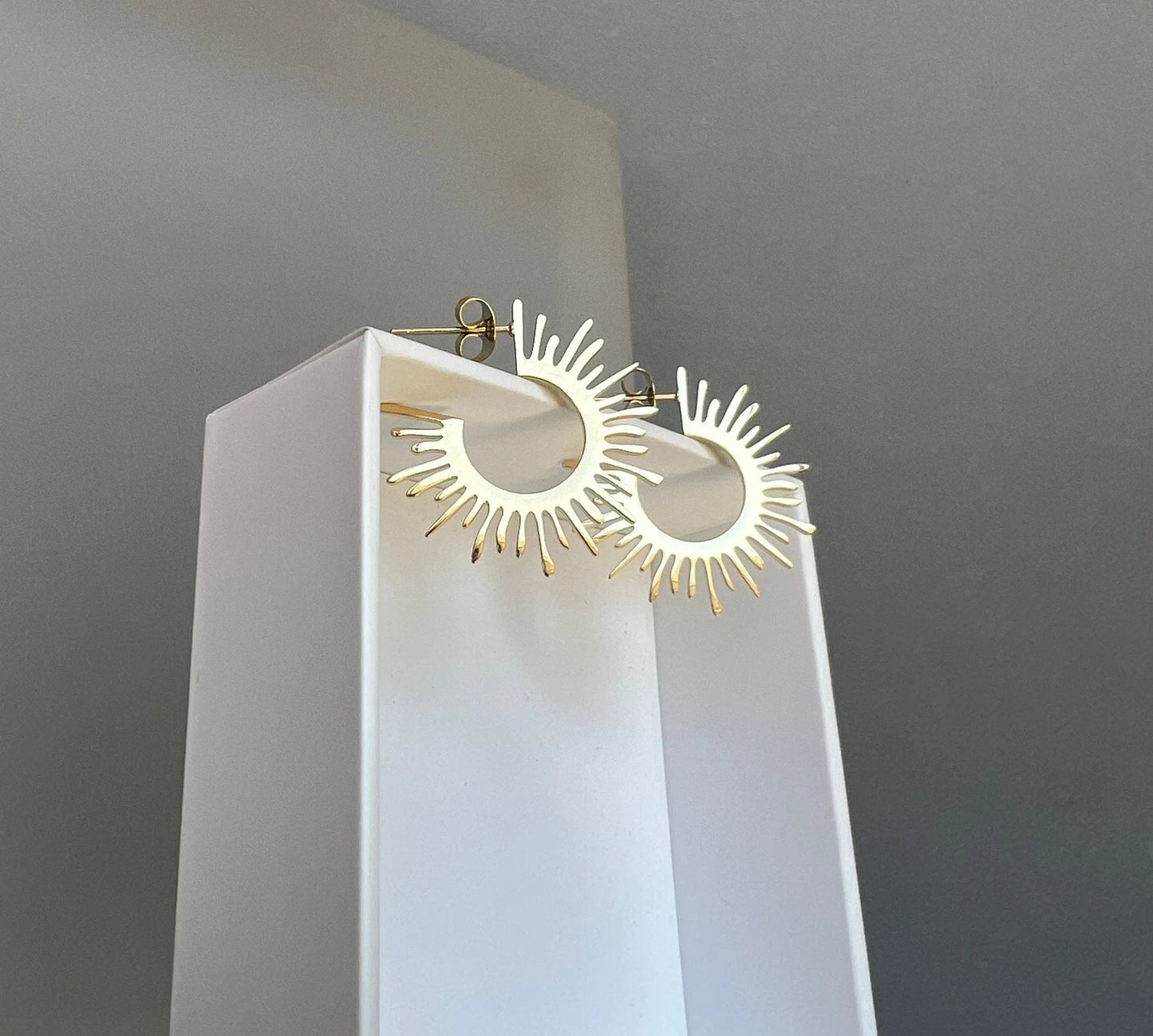 Gold starburst hoop earrings