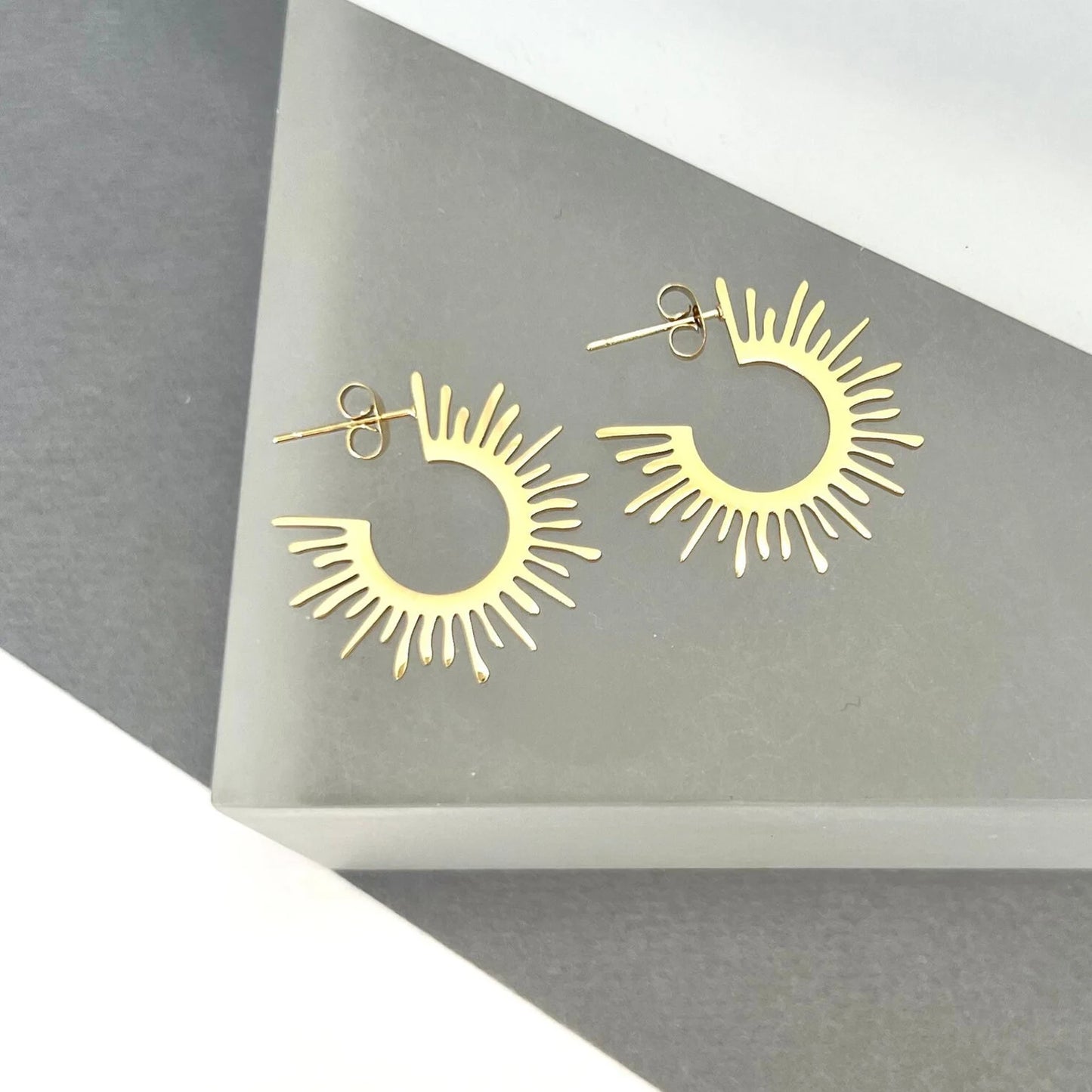 Gold starburst hoop earrings