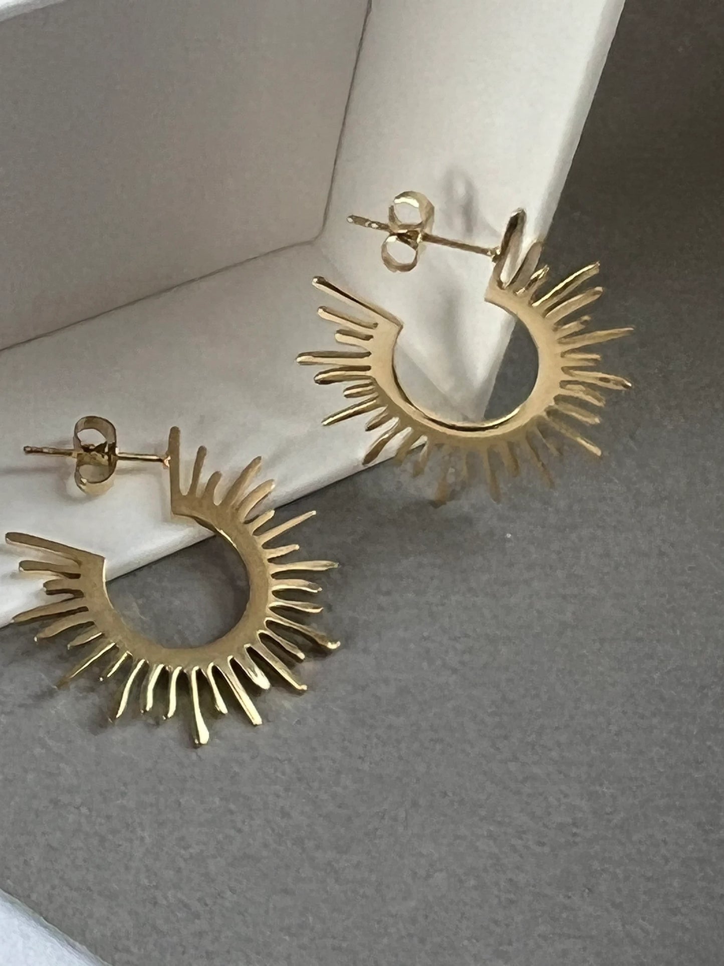 Gold starburst hoop earrings