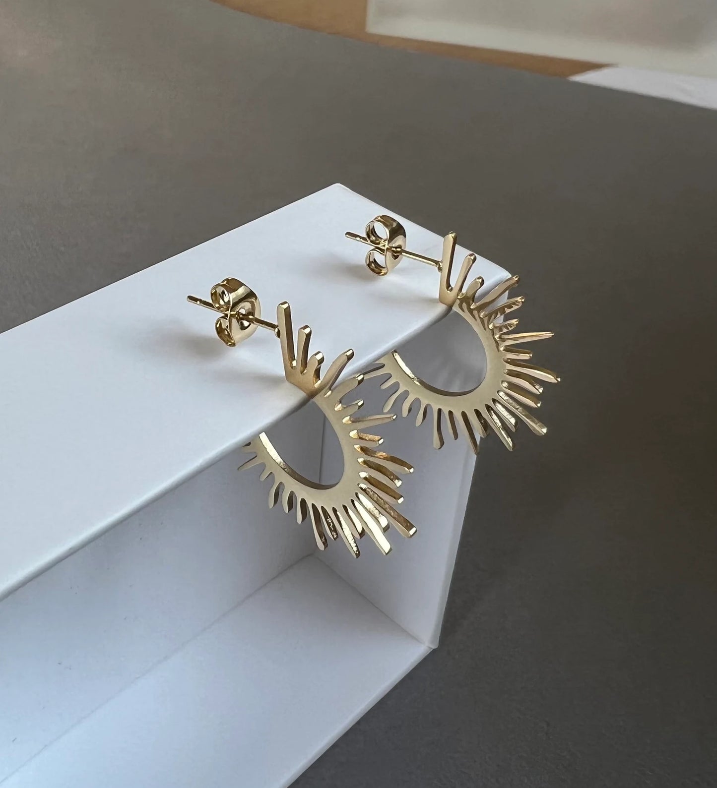 Gold starburst hoop earrings