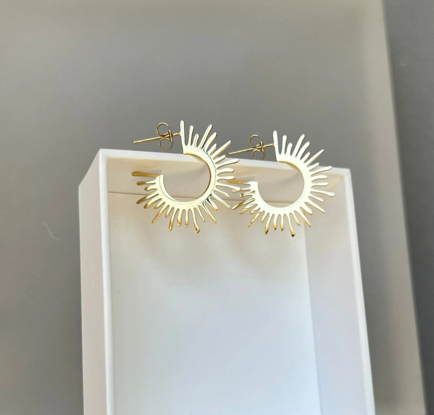 Gold starburst hoop earrings