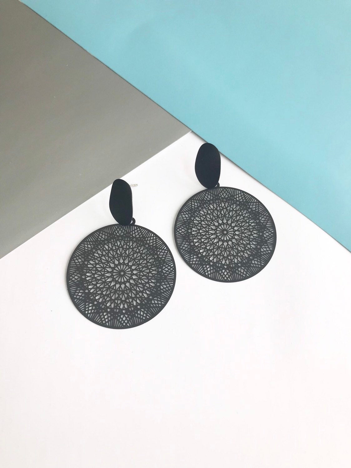 Black filigree disk earrings