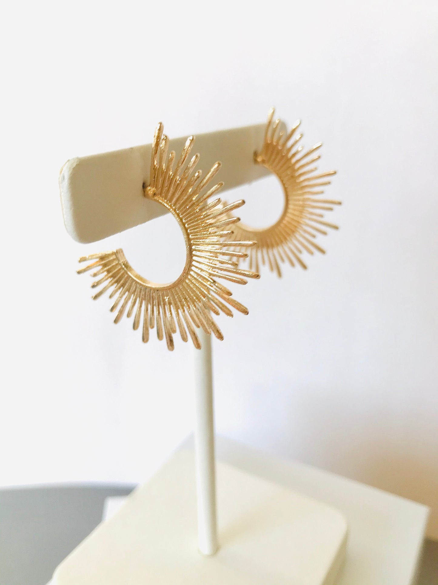 Gold starburst hoop earrings