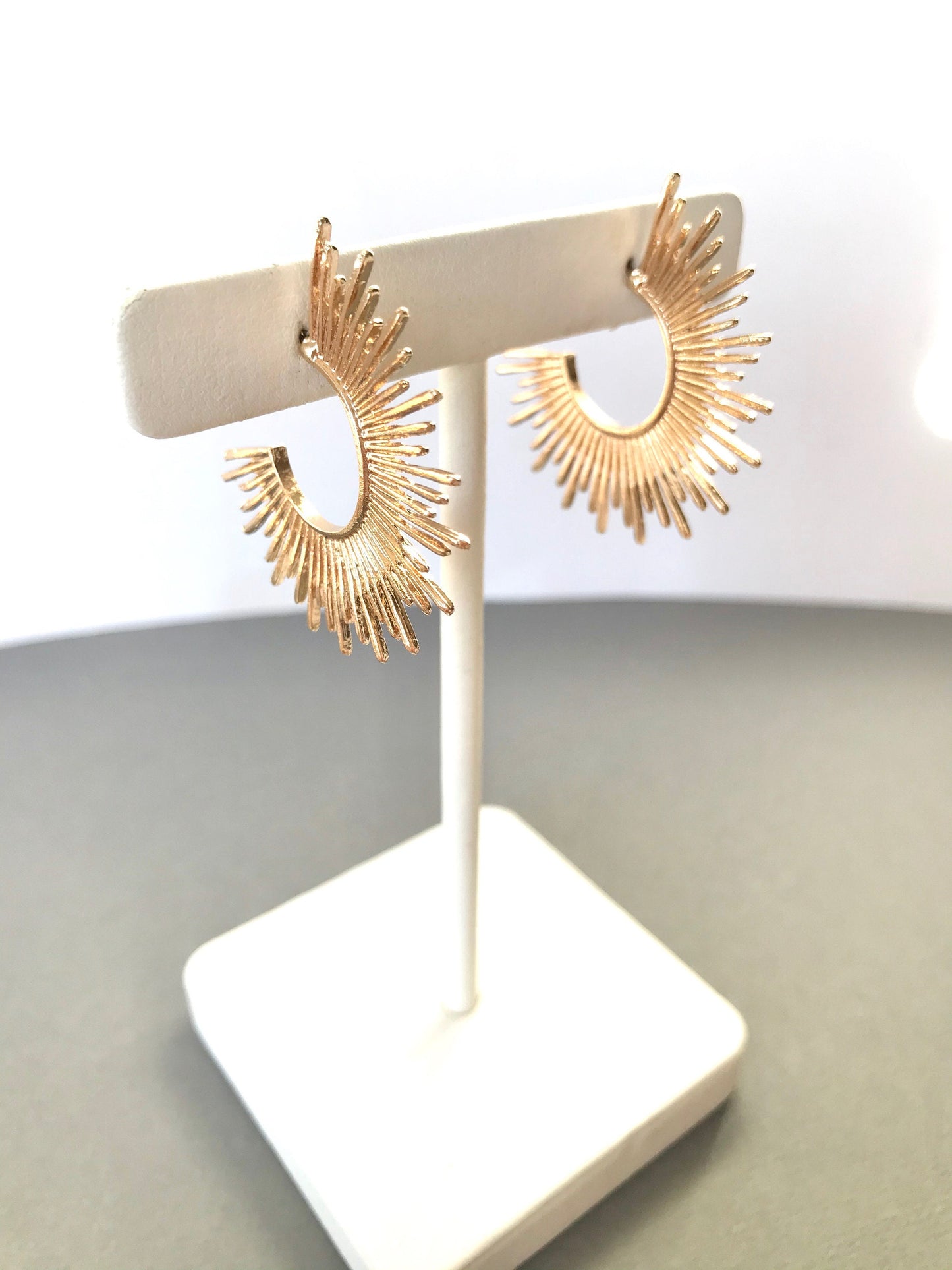 Gold starburst hoop earrings