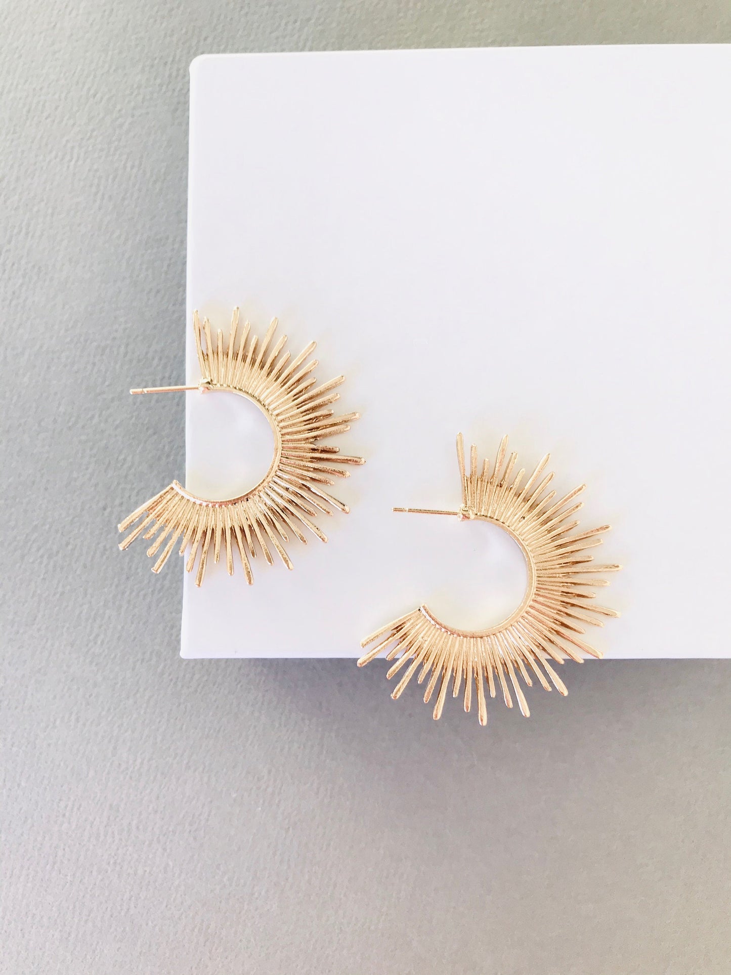 Gold starburst hoop earrings