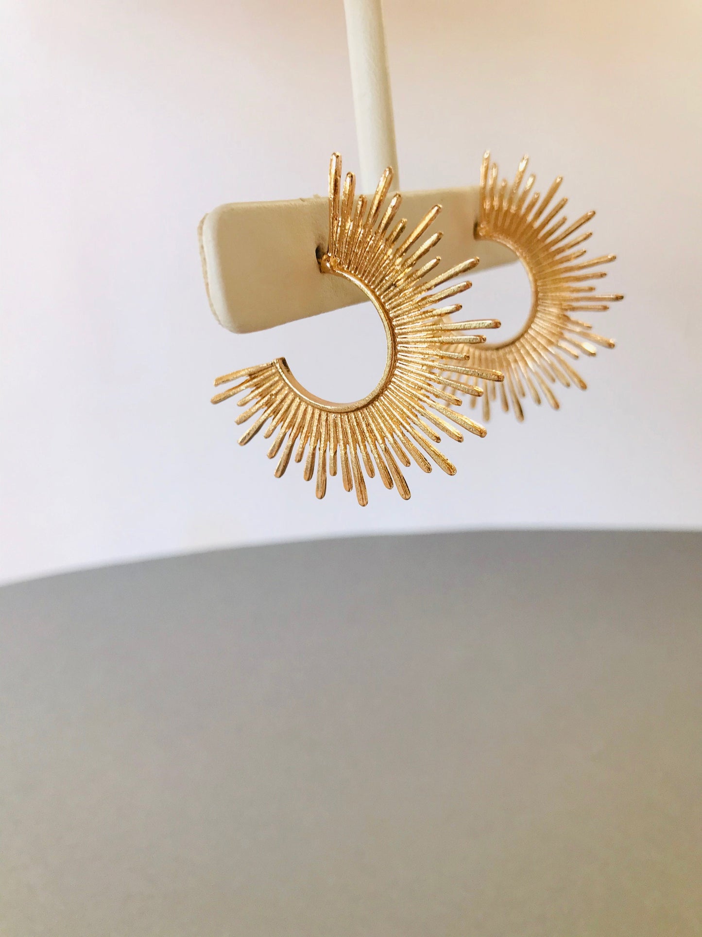 Gold starburst hoop earrings