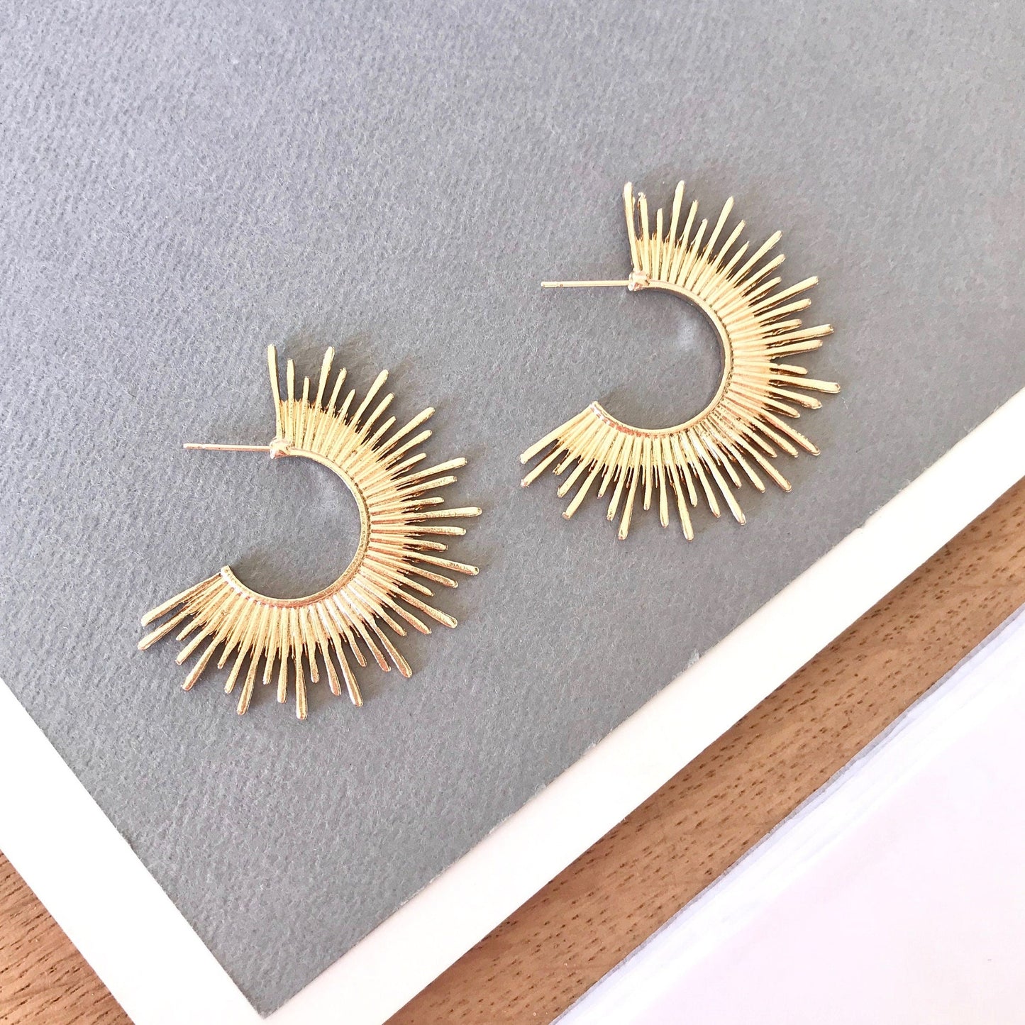 Gold starburst hoop earrings